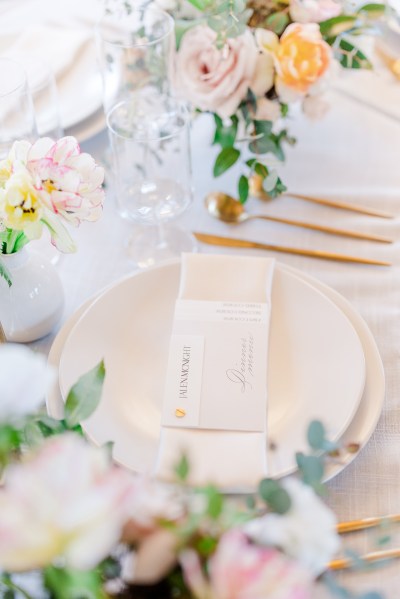 Plates cutlery on table and flowers