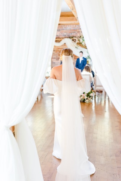 Bride on her own from behind veil hitting floor ground