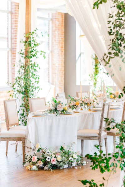 Table setting and flowers roses chair cutlery gold knives and forks