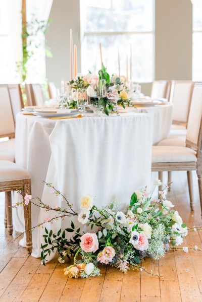 Table setting and flowers roses chair cutlery gold knives and forks