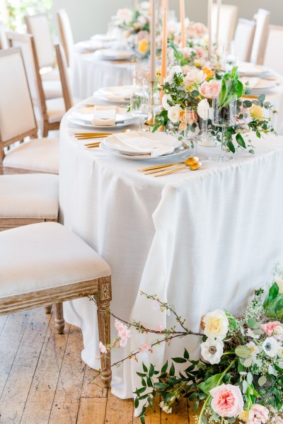 Table setting and flowers roses chair cutlery gold knives and forks