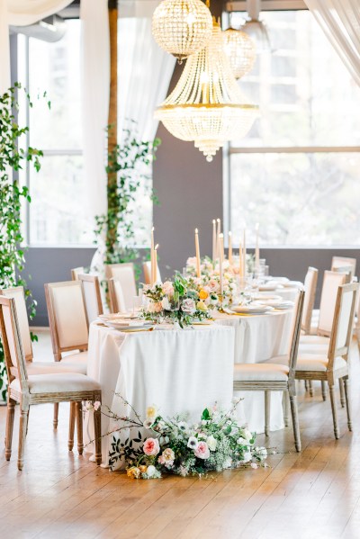 Empty dining room table setting flowers chairs