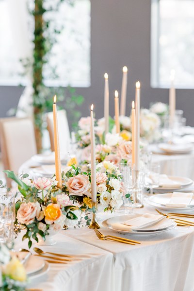 Table setting white pink roses flowers and candles gold theme