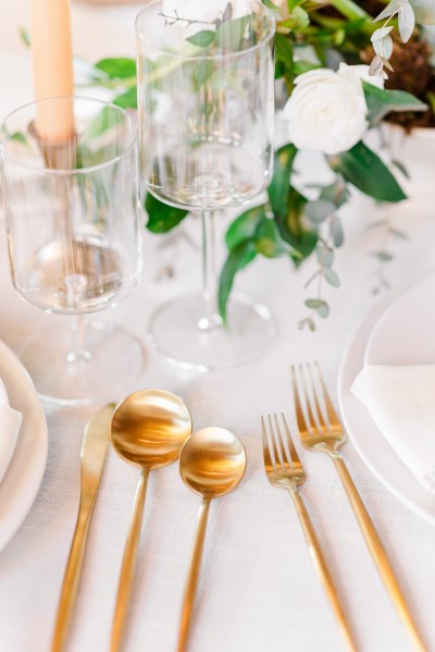 Table setting white pink roses flowers and candles gold theme