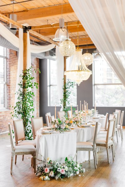 Empty dining room table setting flowers chairs