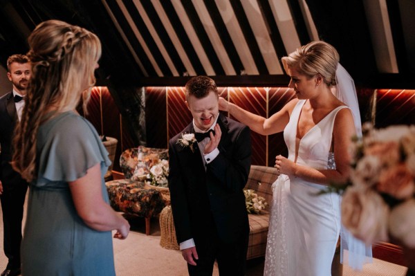 Bride and guests chatting bridesmaid in shot