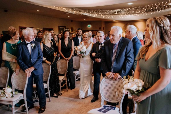 Father of the bride walks his daughter down aisle