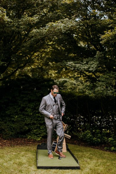 Man in suit standing on grass