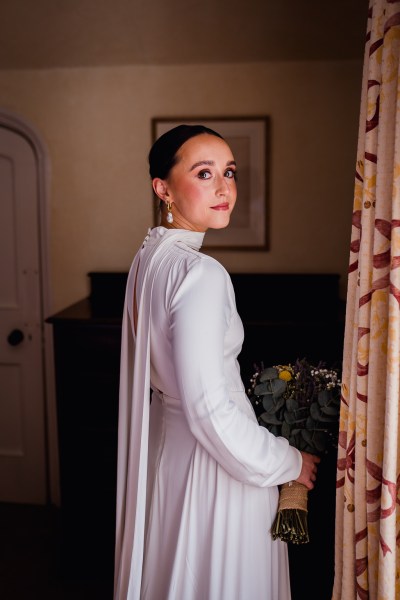 Bride over the shoulder at window