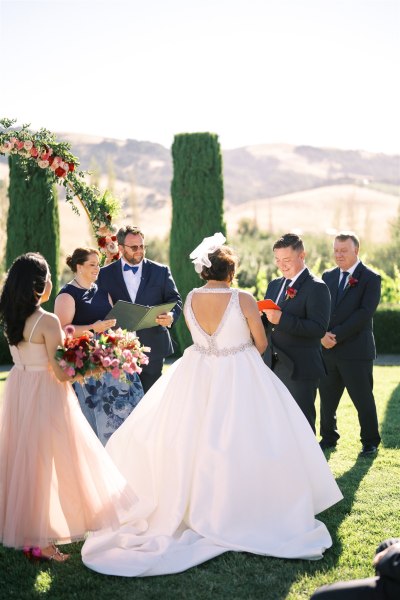 Bride from behind facing groom during ceremony