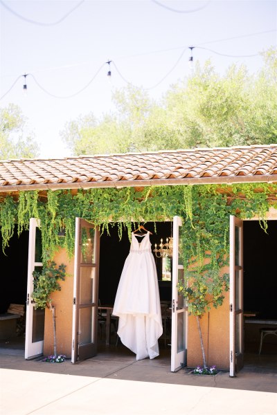 Bridal gown dress hanging up at barn entrance house