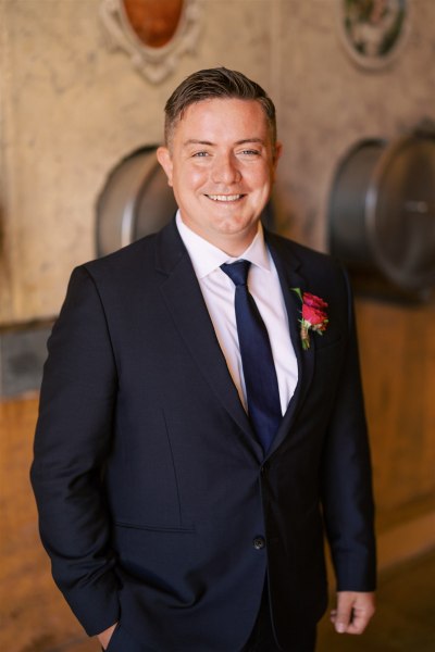 Groom smiles as he gets ready