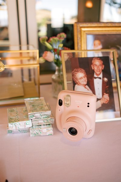 Pink polaroid camera film and mother and father old photo