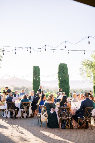 Atmosphere shot of guests seated in garden chatting