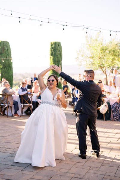 Bride and groom dance outside dancefloor exterior shot surrounded by guests