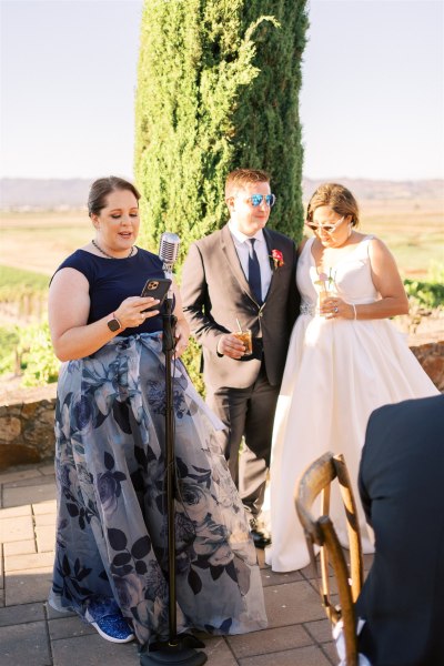 Bride groom and woman giving speech