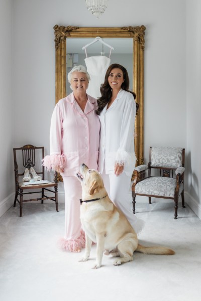 bride mother and Labrador dog pose for a photo