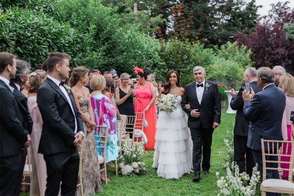 father of the bride walks down the aisle