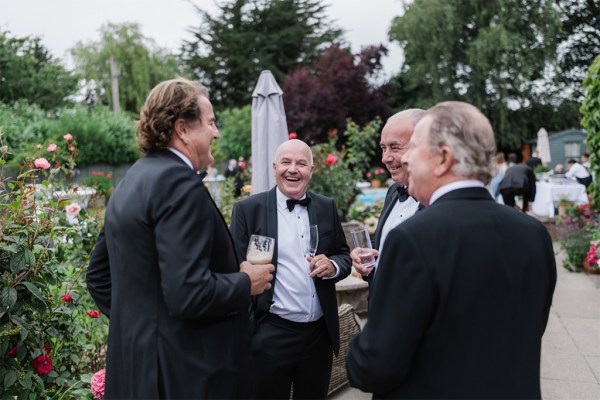 men holding pints of beers chatting away