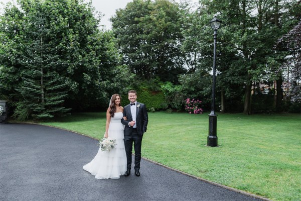 bride and groom walking the gardens linking arms