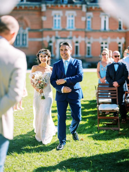 father of the bride walks her down the aisle