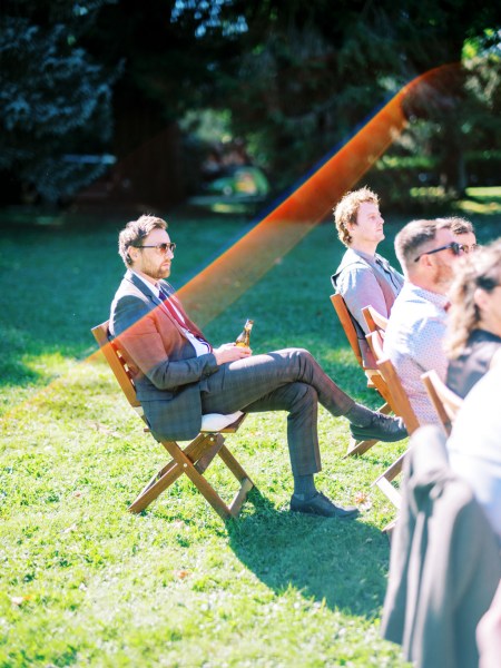 Guests seated during ceremony on grass