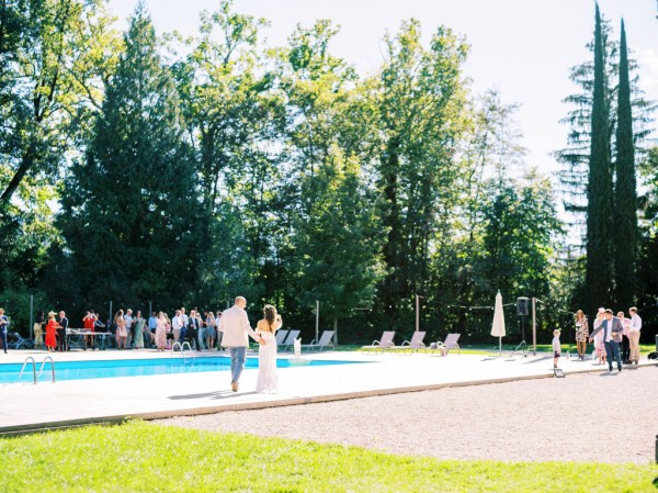 Wide shot view of blue pool and trees