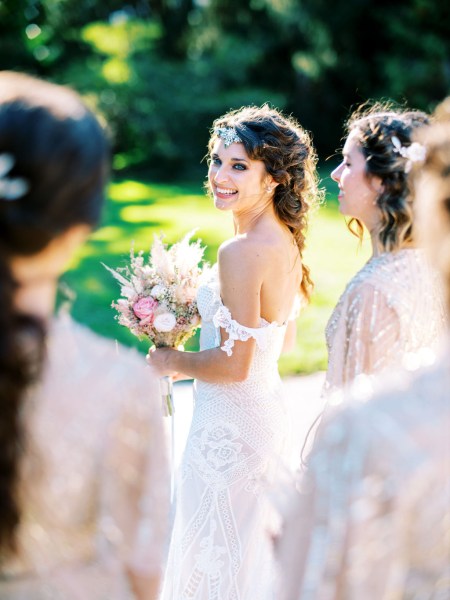 bride looks over her shoulder and smiles