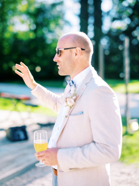 Groom holding pint