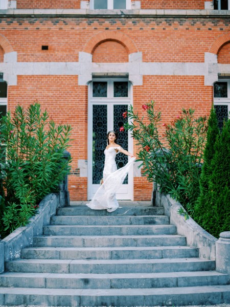 Bride walks down steps to wedding venue