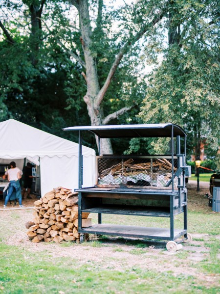 BBQ on grass tent in background