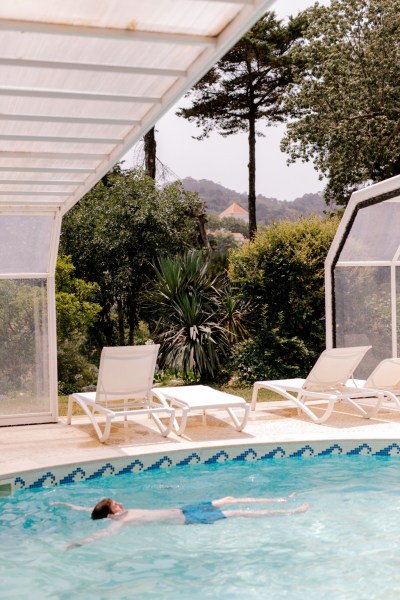 swimming pool and decked chairs outside