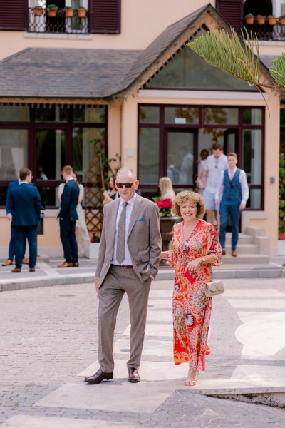 mother and father cross the road venue in background