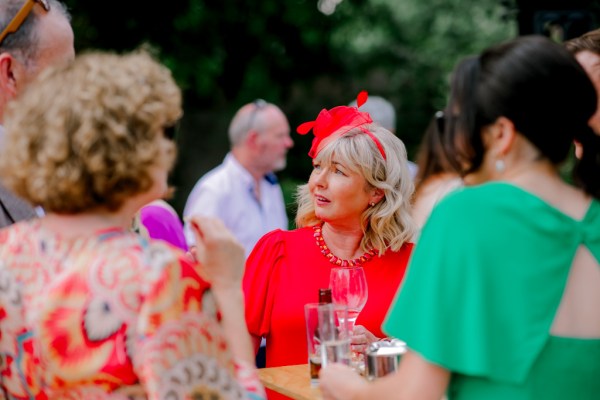 guests chatting holding beverages