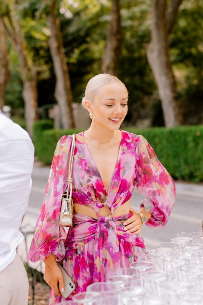 woman wearing pink floral dress smiles