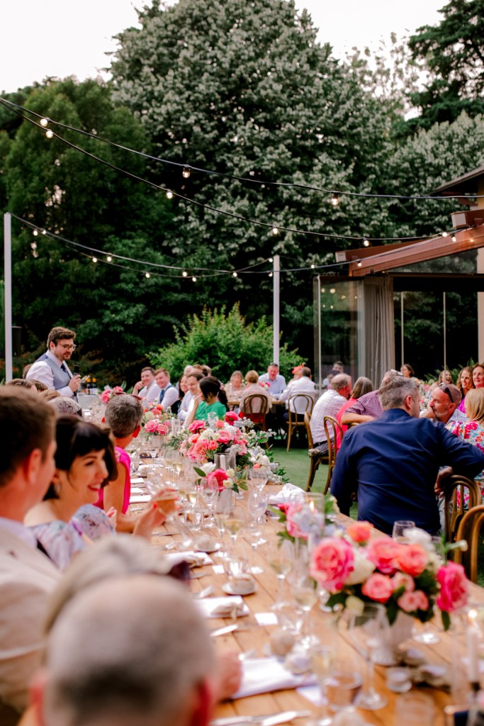 guests groom bride at dining room table outside