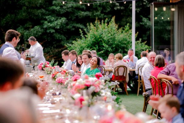 guests groom bride at dining room table outside