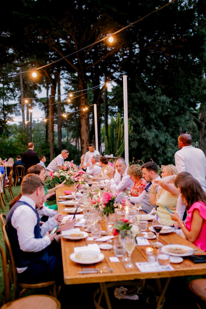 guests groom bride at dining room table outside