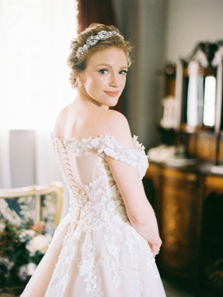 bride looks over the shoulder she is ready