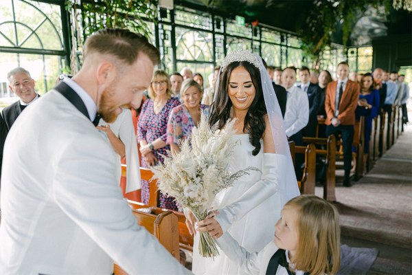 Bride and groom at alter son gives mother away to father