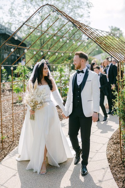 Bride and groom kiss at the alter in front of celebrant