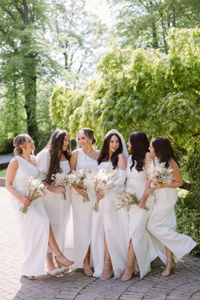 Bride and her bridesmaids celebrate laugh smile