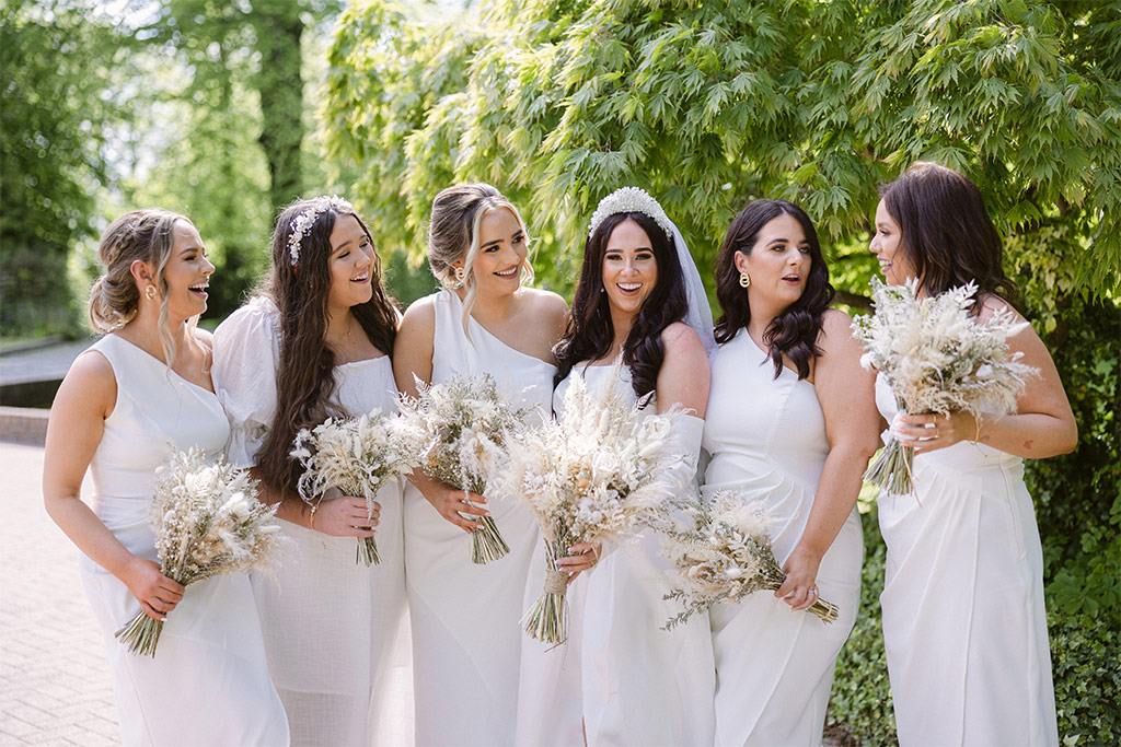 Bride and her bridesmaids celebrate laugh smile