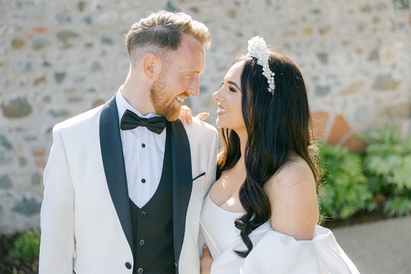 Bride and groom look at each other smiling