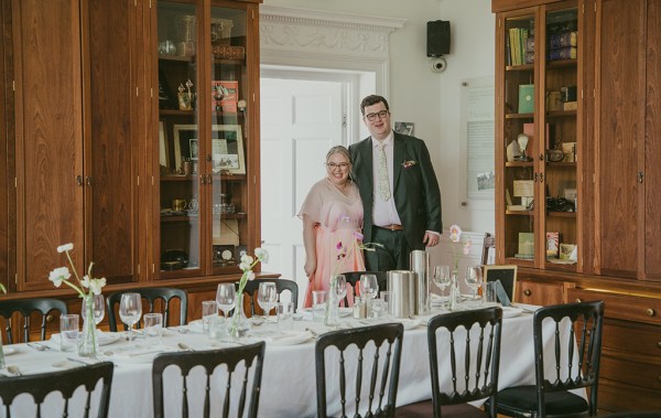 bride and groom stand inside dining room interior setting