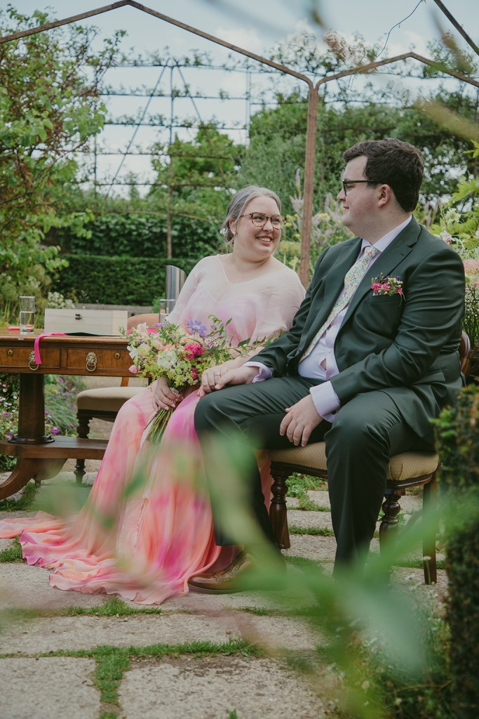 bride and groom seated during ceremony