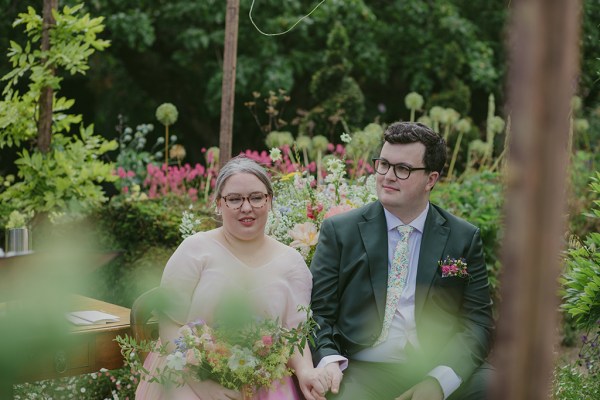 bride and groom seated during ceremony