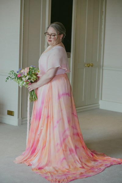 bride is ready she looks over shoulder holding bouquet