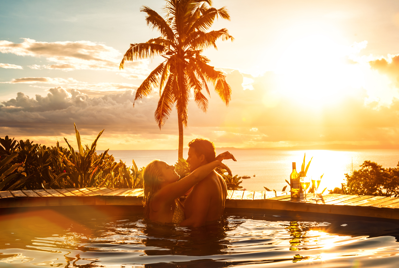 couple swimming in pool on honeymoon