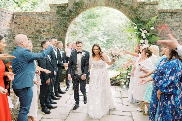 bride and groom exit ceremony as guests start to clap